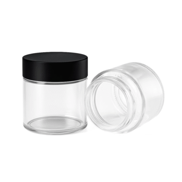 child resistant glass jars in a studio setting one jar standing with a cap and one jar laying down with no cap